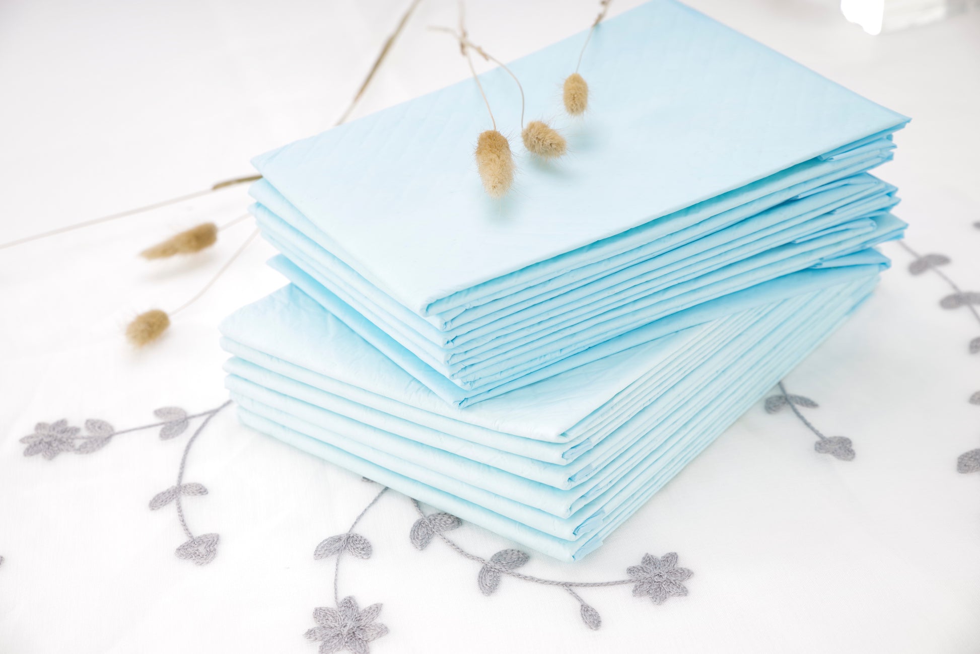 Light blue underpads pile, neatly folded sheets